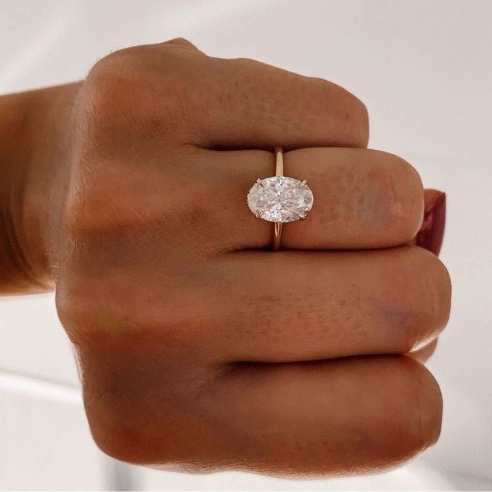 14k rose gold 2.5ct Oval solitaire with hidden halo.